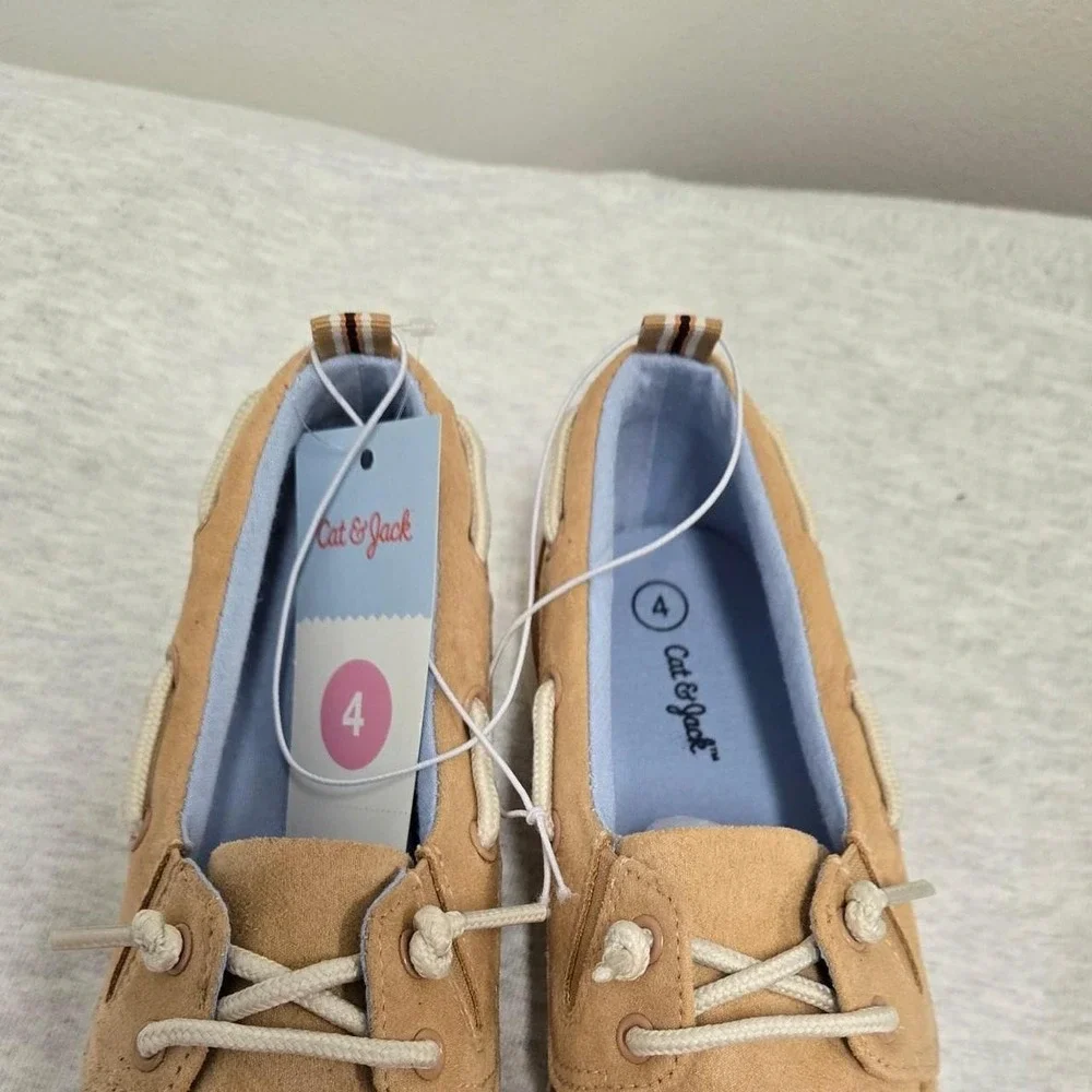 Boys Beige suede boat shoes with white laces. Size: US 4